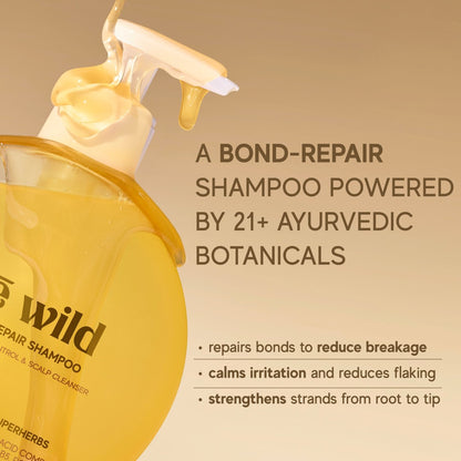 Inde Wild Shampoo bottle with pump and text about bond-repair shampoo and Ayurvedic botanicals on a beige background