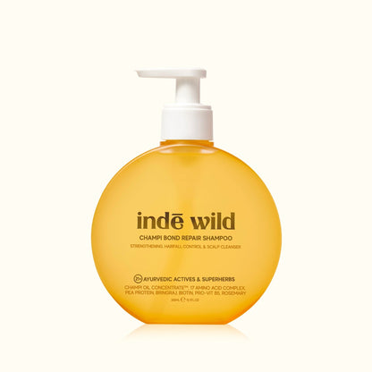 Yellow shampoo bottle with white pump labeled 'inde wild' on a white background